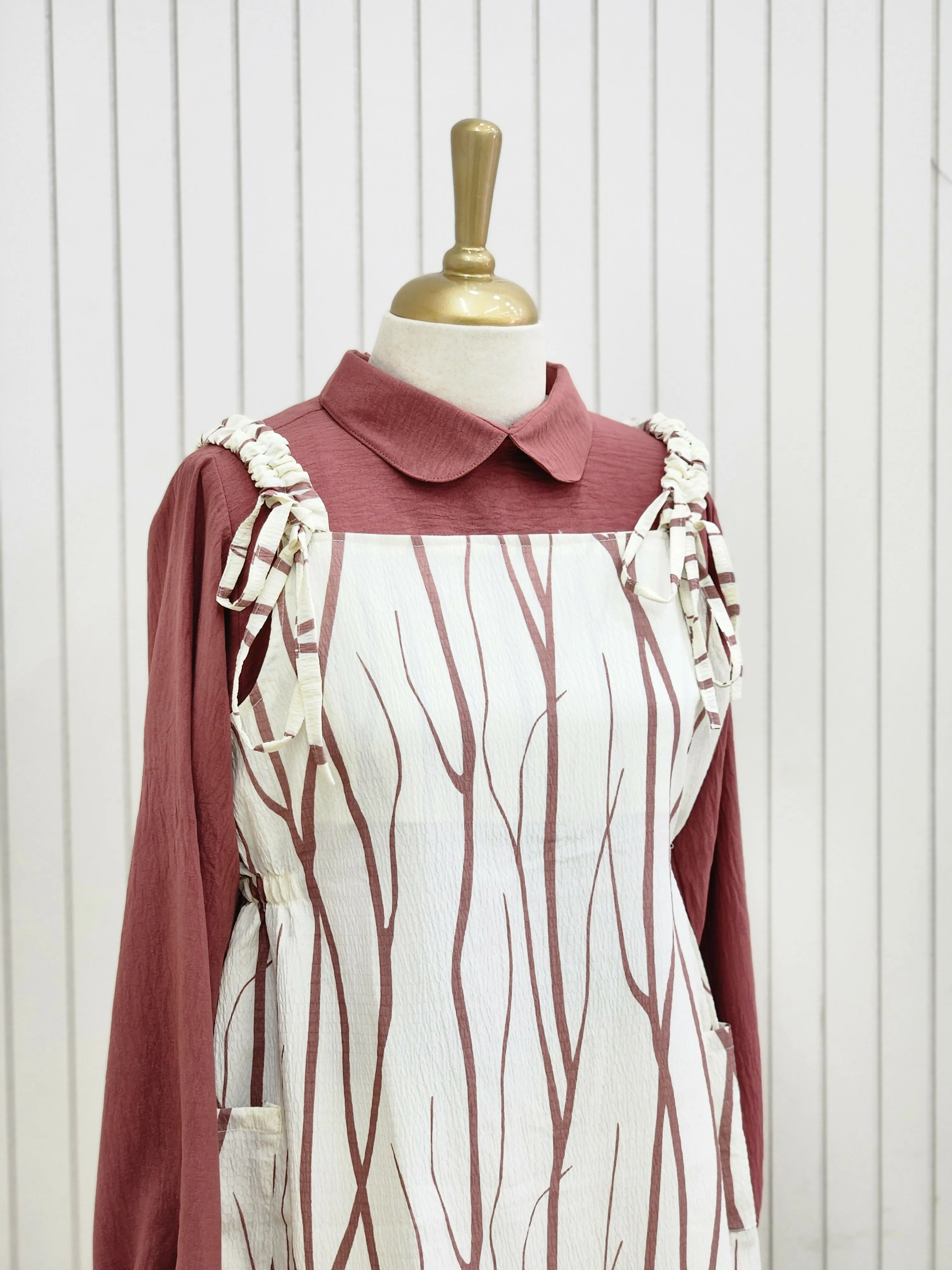A knee length top raspberry rose color pattern and inner