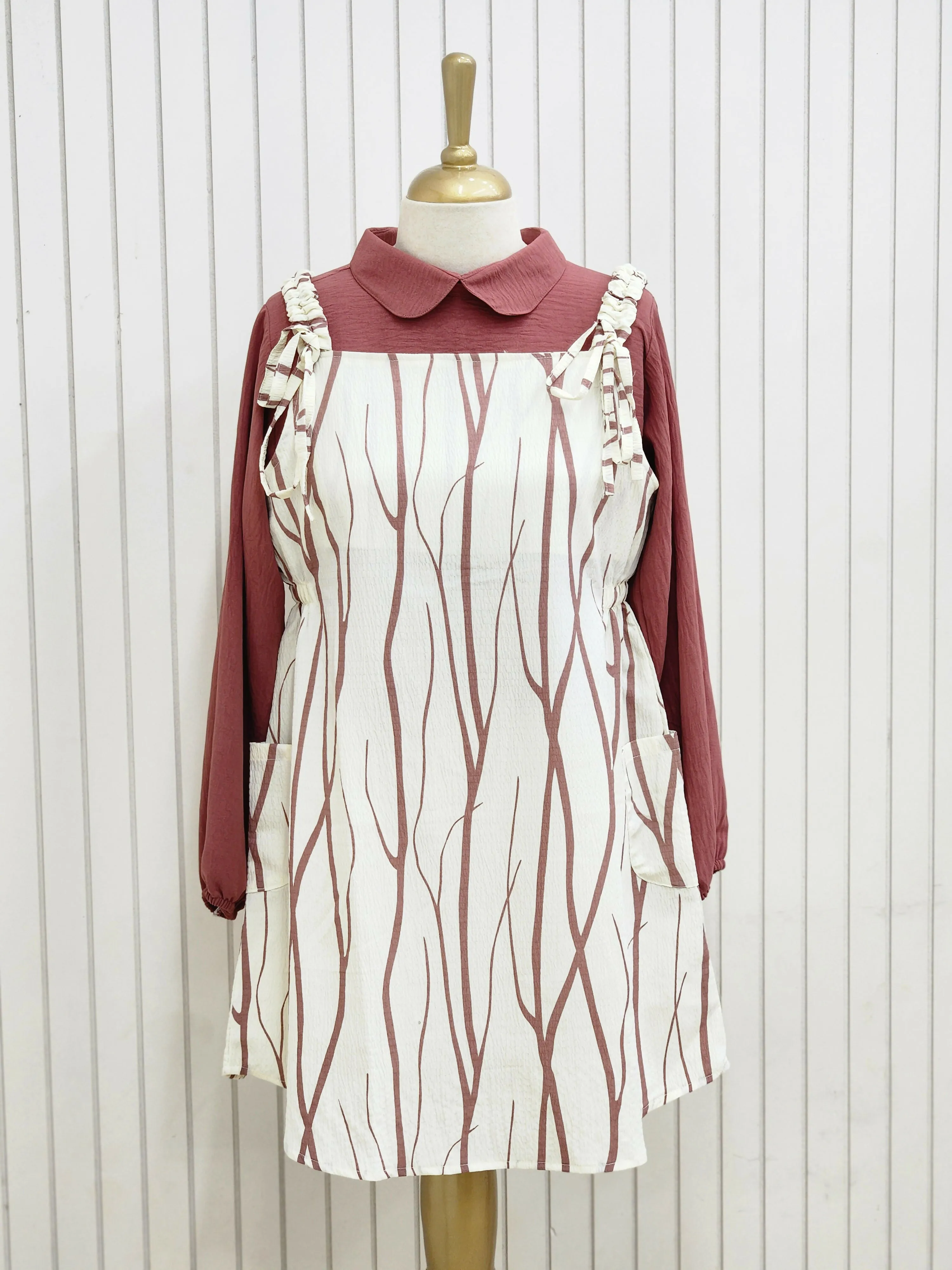 A knee length top raspberry rose color pattern and inner