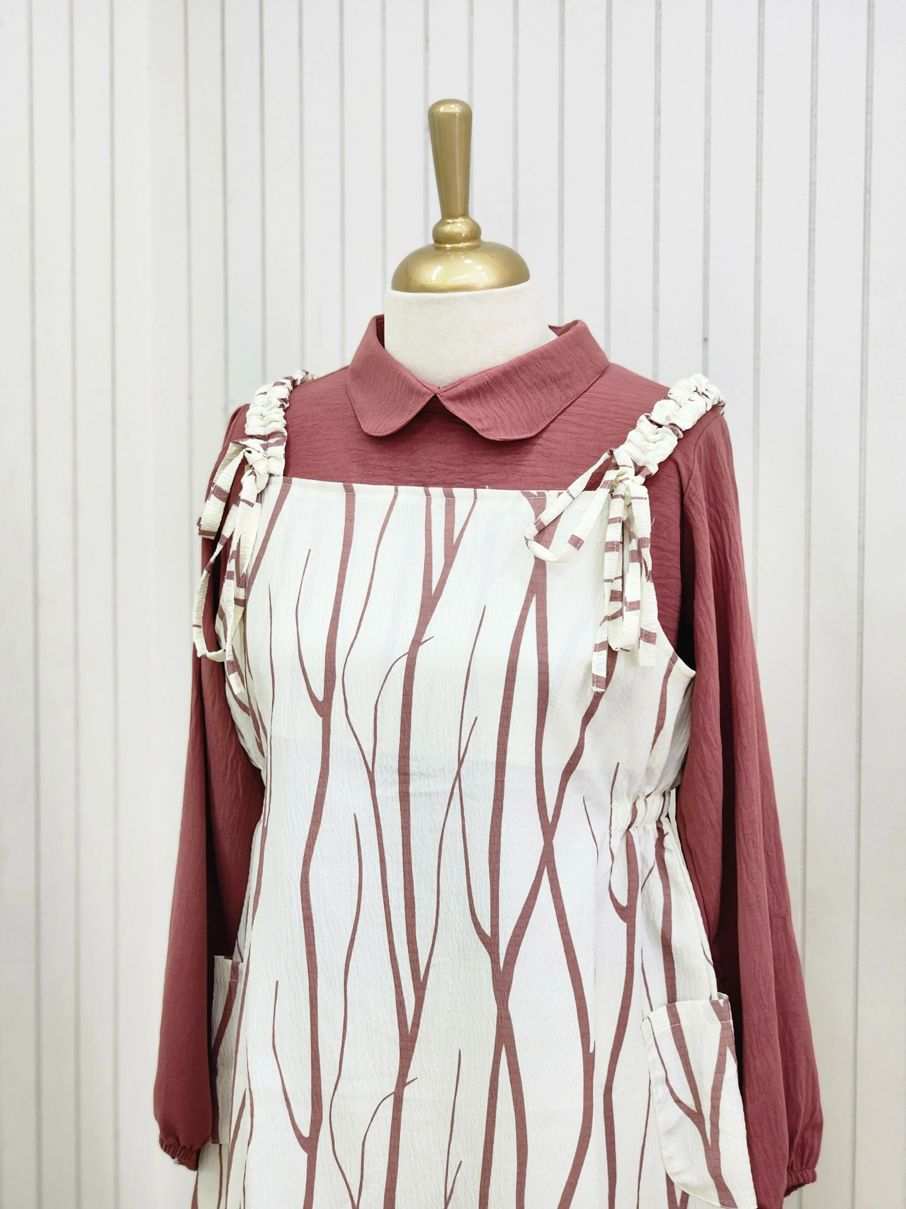 A knee length top raspberry rose color pattern and inner